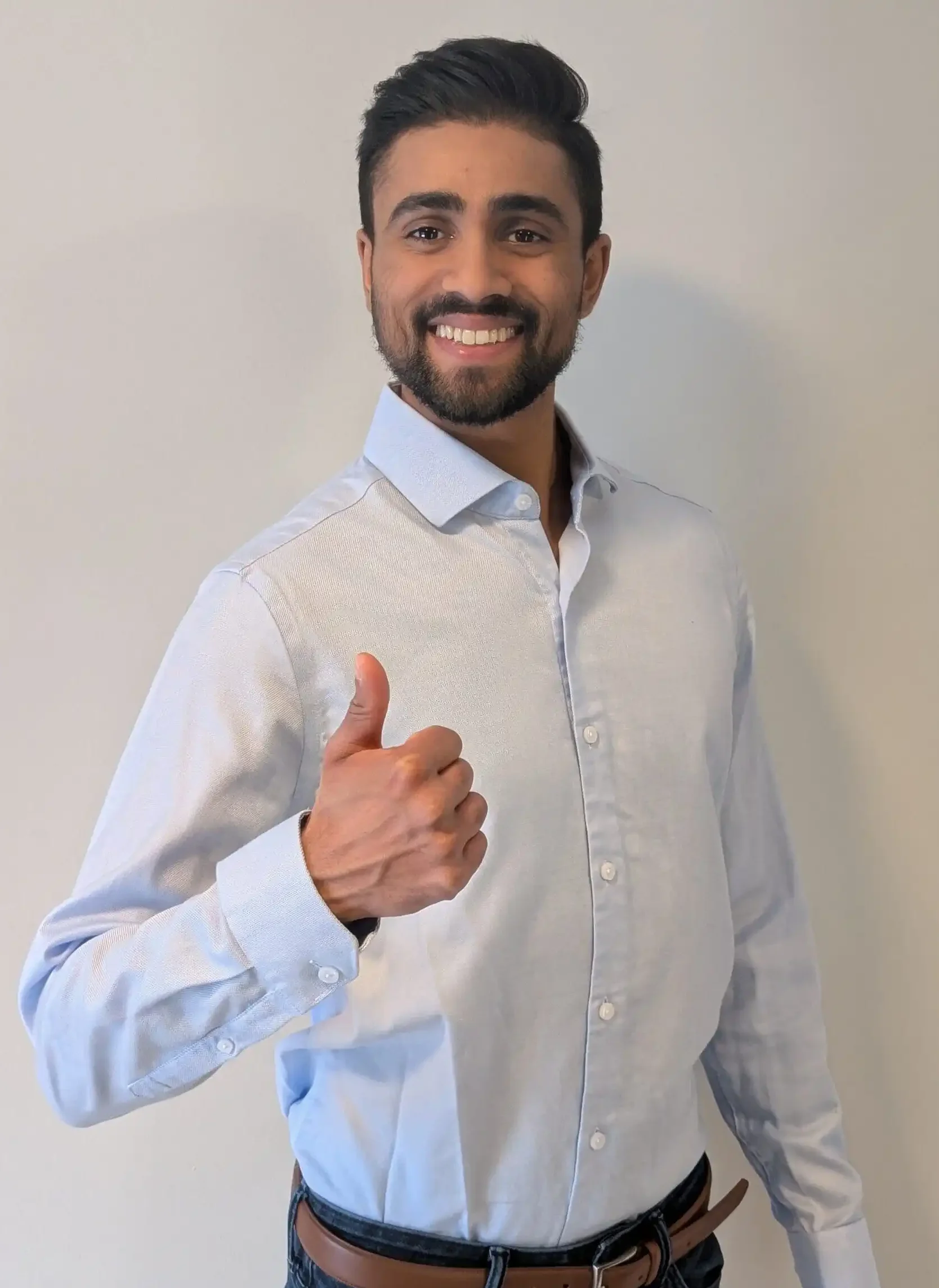 The founder of Inspire Learning, Ilhaam Zafar. He is smiling brightly while giving a thumbs up.